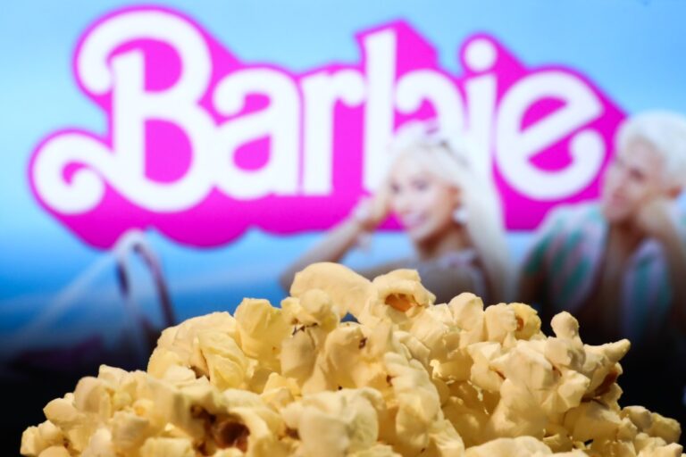 A popcorn and Barbie movie website displayed on a screen in the background are seen in this illustration photo taken in Krakow, Poland on August 1, 2023.